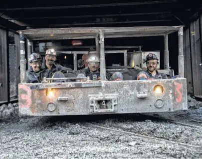  ?? Andrew Harrer / Bloomberg ?? Miners ride a shuttle out of a mine entrance this month at the newly opened Ramaco Resources Stonecoal Alma mine near Wylo, W.Va. U.S. coal exports are up 60 percent from a year ago.