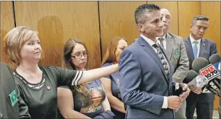  ?? Al Seib Los Angeles Times ?? TEACHER Jennifer Garcia, who had reported signs that Gabriel Fernandez was being abused before the boy was killed, comforts an emotional Jon Hatami, the prosecutor, after sentencing.