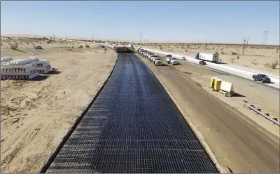  ??  ?? In this west-facing photo, taken in late winter from the top of the Ogilby Road overcrossi­ng, the steel rebar skeleton of the CRCP paving process is shown in this unpaved portion of the eastbound lanes. COURTESY PHOTO CALTRANS