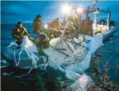  ?? U.S. NAVY ?? Sailors assigned to Explosive Ordnance Disposal Group 2 recover balloon debris Sunday off Myrtle Beach, S.C.