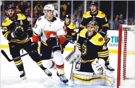  ?? ASSOCIATED PRESS FILE PHOTO ?? David Krejci, left, and goaltender Tuukka Rask of the Boston Bruins defend against the Calgary Flames’ Mark Jankowski in 2018 in Boston. The two Bruins veterans won the Stanley Cup in 2011.