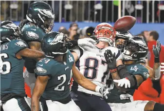  ?? Timothy A. Clary / AFP / Getty Images ?? New England tight end Rob Gronkowski (87), surrounded by Philadelph­ia defenders, can’t corral Tom Brady’s Hail Mary pass on the final play of the game.