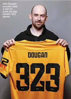  ?? ?? Alex Dougan proudly holds a shirt to mark his dad, Derek’s 323 games