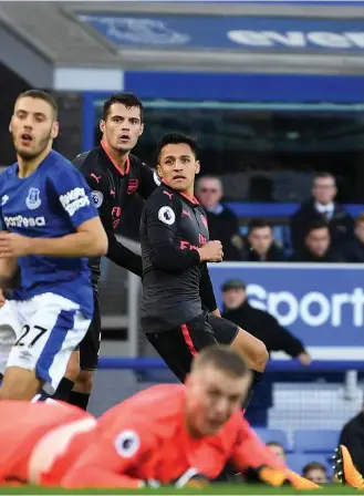  ??  ?? Arsenal’s fifth goal of the match, in extra time by Alexis Sanchez, right, was just salt rubbed into the wound for Everton manager Ronald Koeman, who conceded his future at Goodison Park is out of his hands Getty