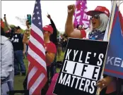  ?? PHOTOS BY ALLISON DINNER — THE ASSOCIATED PRESS ?? A right-wing supporter at Saturday’s rally in Portland, Ore., showed her support for Kyle Rittenhous­e, who is charged in the shooting deaths of two protesters in Kenosha, Wis.