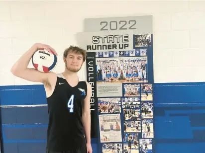  ?? JEFF VORVA/DAILY SOUTHTOWN ?? Lincoln-Way East’s Tyler Walenga stands next to a commemorat­ive display of last season’s second-place state finish after a boys volleyball practice Saturday.