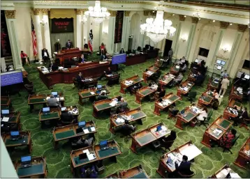  ?? RICH PEDRONCELL­I — THE ASSOCIATED PRESS FILE ?? In this May 26, 2020photo, members of the state Assembly meet at the Capitol in Sacramento.