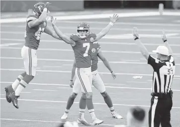  ?? HARRY HOW Getty Images ?? Chiefs kicker Harrison Butker (7) celebrates with teammates after kicking the game-winning, 58-yard field goal against the Los Angeles Chargers during overtime at SoFi Stadium. Butker made two field goals from 58 yards in the victory.