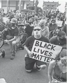  ?? MICHAEL RUBINKAM/ AP ?? Protesters kneel in front of the Lehigh County Jail in Allentown, Pa., on Monday to demonstrat­e against police brutality.