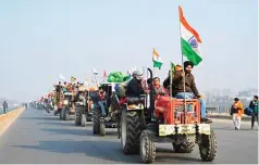  ?? ?? Indian farmers in a tractor rally in New Delhi ito protest new agricultur­al laws.