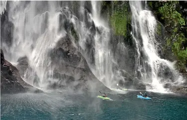  ??  ?? Framed by silvery waterfalls, Milford Sound is the most popular destinatio­n in the park.