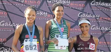  ?? Picture: AMANDA NANO ?? WINNING STRIDES: From left, Sandiswa Kundulu, Thembela van der Berg and Sitha Sigenu on the winners’ podium after finishing the Galaxy Bingo 10km Challenge