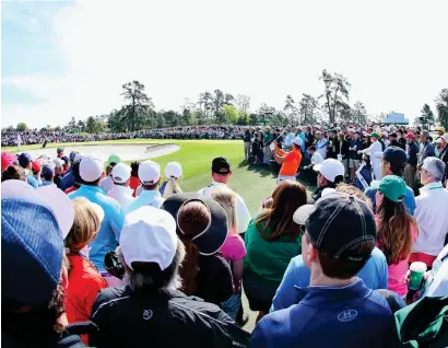  ?? Photograph: Getty ?? Jason Day, hard to miss in his orange shirt, had a better day, shooting a 69