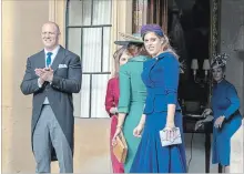  ?? WPA POOL GETTY IMAGES ?? Mike Tindall and Princess Beatrice watch as Princess Eugenie and Jack Brooksbank leave Windsor Castle after their wedding for an evening reception at Royal Lodge on Oct. 12.