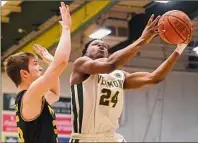  ?? Jessica Hill / Associated Press ?? Vermont's Ben Shungu goes up for a shot as UMBC's Nathan Johnson defends in the first half of the America East final Saturday in Burlington, Vt. Shungu finished with 19 points.