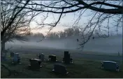  ?? ASSOCIATED PRESS FILE PHOTO ?? Morning fog blankets a cemetery in West Virginia.