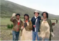  ??  ?? August 2007: Wande Khar (second right) takes a photo with herders from nearby Gegyai County at the foot of Mount Kailash in Ngari, Tibet. The herders came to circle the mountain as a pilgrimage. courtesy of Wande Khar