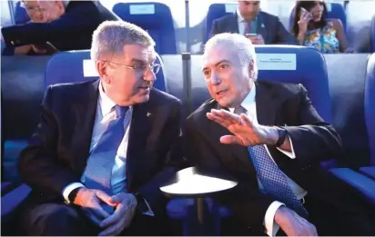  ??  ?? Internatio­nal Olympic Committee President Thomas Bach, left, and Brazil interim President Michel Temer talk in Maracana Stadium before the opening ceremony Photo: AP