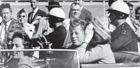  ?? FATEFUL DAY: US President John F. Kennedy waves from his car in a motorcade in Dallas, Texas, on November 22, 1963. ??