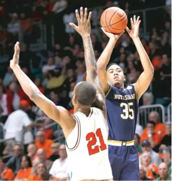  ?? | AP ?? Forward Bonzie Colson ( 35) gets a shot off against Kamari Murphy in Notre Dame’s ACC road victory.