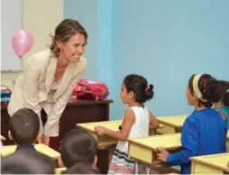  ?? HANDOUT VIA AFP/GETTY IMAGES ?? Asma Assad, Syria’s first lady, visits a school for the children of fallen soldiers in the coastal city of Tartus, for the start of the new school year on Sept. 7.