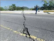  ?? CARLOS GIUSTI/AP ?? A crack runs through a bridge along Road 116 after a magnitude 5.9 earthquake Saturday in Guanica, Puerto Rico.