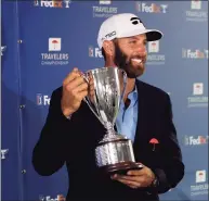  ?? Frank Franklin II / Associated Press ?? Dustin Johnson poses with the trophy after winning the Travelers Championsh­ip on June 28.