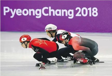  ?? ROBERTO SCHMIDT/AFP/GETTY IMAGES ?? China’s Wu Dajing, France’s Sebastien Lepape and Canada’s Charles Hamelin compete in a men’s 1,000-metre short-track speedskati­ng heat Tuesday at Gangneung Ice Arena. Hamelin and the 5,000-metre relay team, meanwhile, advanced Tuesday to the final.