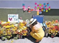  ?? DAMIAN DOVARGANES/ASSOCIATED PRESS ?? A makeshift memorial of flowers, candles and notes grows on the sidewalk Sunday outside the Los Feliz Trader Joe’s store in Los Angeles. A day earlier, Trader Joe’s employee Melyda Corado was shot and killed at the store by a suspect after being chased...