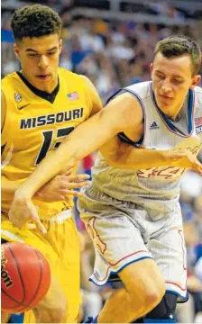  ?? THE ASSOCIATED PRESS ?? Missouri forward Michael Porter Jr., left, and Kansas forward Mitch Lightfoot battle for a loose ball during an exhibition game Oct. 22 in Kansas City, Mo.