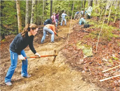  ?? STAFF FILE PHOTO ?? College students from dozens of universiti­es spend their spring break working to build sections of the Cumberland Trail on the plateau near Barker Camp Road in 2011. Officials are hoping to find new volunteers to help maintain the trail.