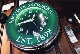  ?? Arnold Gold / Hearst Connecticu­t Media ?? An Archie Moore’s clock hangs at the end of the bar during the restoratio­n.