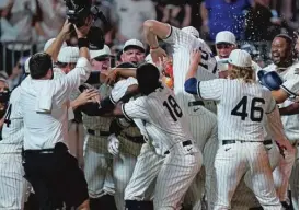  ?? CHARLIE NEIBERGALL/AP ?? The Sox celebrate Tim Anderson’s walk-off home run in the ninth — the last of a combined eight homers between the two teams.