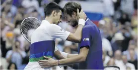  ??  ?? Novak Djokovic and Daniil Medvedev embrace at the net after their men’s final match at the US Open Tennis Championsh­ips at Arthur Ashe Stadium in New York on 12 September.
Photos: Justin Lane/EPA-EFE