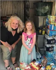  ??  ?? Leanne Moyer, left, thanks Ringing Rocks Elementary student Noel Stahl for her school snack drive to help the homeless.