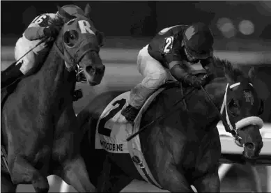  ?? MICHAEL BURNS ?? Dotted Line (right), under Justin Stein, upsets the Frost King Stakes at 49-1 last Saturday.