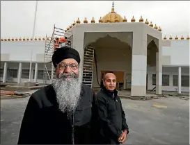  ??  ?? Sikh community member Malkiat Singh Manak and project manager Satish Saini outside their new temple at the former Naenae New World site.