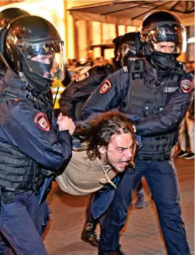  ?? ?? Fury: A young protester rages as he is hauled away by police
