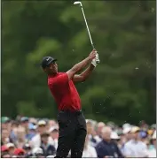  ?? DAVID J. PHILLIP — THE ASSOCIATED PRESS, FILE ?? Tiger Woods hits on the 12th hole during the final round for the Masters in Augusta, Ga., on April 14. Woods hit 9-iron to the fat of the green after watching two other players hit into the water.