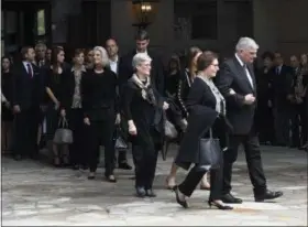  ?? KATHY KMONICEK — THE ASSOCIATED PRESS ?? Family members, including Franklin Graham, right, walk to vehicles before the body of Rev. Billy Graham leaves the Billy Graham Training Center at the Cove on Saturday in Asheville.