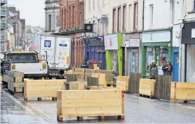  ??  ?? Wood you believe it? The barriers have caused a stir in the city