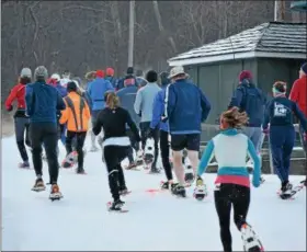  ?? MARIAN DENNIS — DIGITAL FIRST MEDIA ?? Racers braced freezing temperatur­es Saturday as they embarked on the annual Snowshoe Race up the slopes at Spring Mountain Adventures.