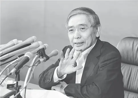  ??  ?? Kuroda, governor of the Bank of Japan, speaks at a news conference at the central bank’s headquarte­rs in Tokyo on Friday, July 29. The BOJ kept its key monetary tools unchanged, and will mount a comprehens­ive review of its policy framework due to...