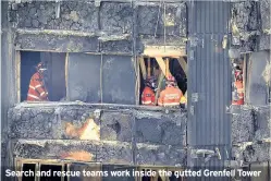  ??  ?? Search and rescue teams work inside the gutted Grenfell Tower