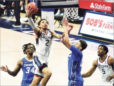  ?? David Butler II / Pool Photo via AP ?? UConn’s James Bouknight (2) drives the ball to the basket against Creighton in the second half on Sunday.