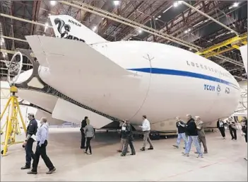  ?? Photograph­s by Al Seib
Los Angeles Times ?? THE LMH- 1 airship is intended to carry truck- size loads to areas that are inaccessib­le to more traditiona­l modes of transporta­tion. Above, a prototype of the airship at a Skunk Works hangar in Palmdale.