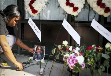  ?? JOHN MINCHILLO — THE ASSOCIATED PRESS ?? Jamila McNichols, sister of slain mass shooting victim Thomas “TJ” McNichols, mourns beside a memorial near the scene of the mass shooting Monday in Dayton, Ohio.