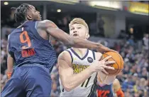  ?? [AP PHOTO/DARRON CUMMINGS] ?? Indiana's' Domantas Sabonis, right, puts up a shot against Oklahoma City's Jerami Grant during the second half of Thursday's game in Indianapol­is. Sabonis, a former Thunder player, hit two critical free throws late in the Pacers' 108-106 comeback win.