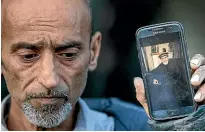  ?? NINE ?? Omar Nabi holds a photo of his father, Haji-Daoud Nabi, who was killed in the Al Noor Mosque in Christchur­ch.