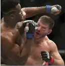  ?? Gregory Payan ?? The Associated Press Stipe Miocic, right, lands a right hand to Francis Ngannou during their UFC 220 heavyweigh­t championsh­ip bout on Jan. 20 in Boston.